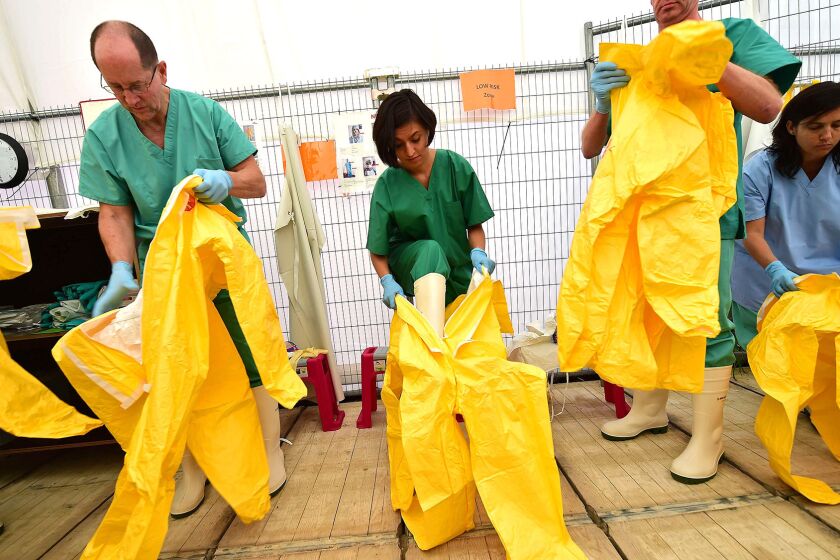 Volunteers train with Doctors Without Borders at a simulated Ebola treatment center in Brussels before going to help fight the spread of the virus in West Africa.