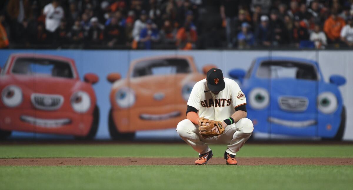 Giants' Evan Longoria kneels on the field during the ninth inning of Thursday's game against the Dodgers in San Francisco. 