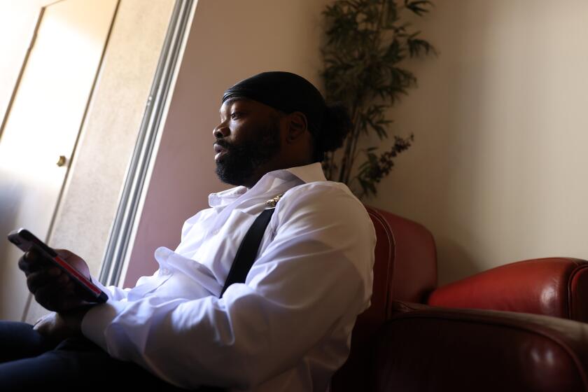 ORANGE COUNTY, CA - APRIL 08: Tory Johnson, founder of Black Lives Matter Huntington Beach, is planning a counter-protest to the upcoming "White Lives Matter" rally in Huntington Beach on Thursday, April 8, 2021 in Orange County, CA. Here he answers a call from a person wishing to know more about the counter-protest. (Dania Maxwell / Los Angeles Times)