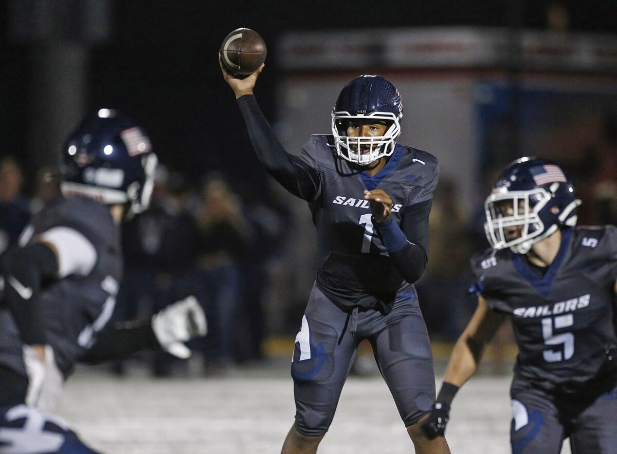 Newport Harbor quarterback Jaden O'Neal (1) finds an open receiver against Huntington Beach on Friday night.