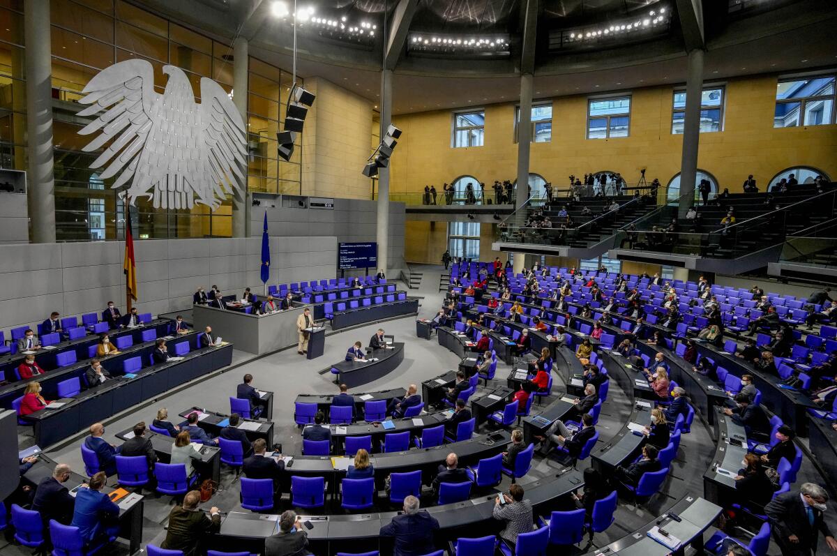 Lawmakers attend a debate about a vaccination mandate at the parliament Bundestag in Berlin, Germany, Wednesday, Jan. 26, 2022. (AP Photo/Markus Schreiber)
