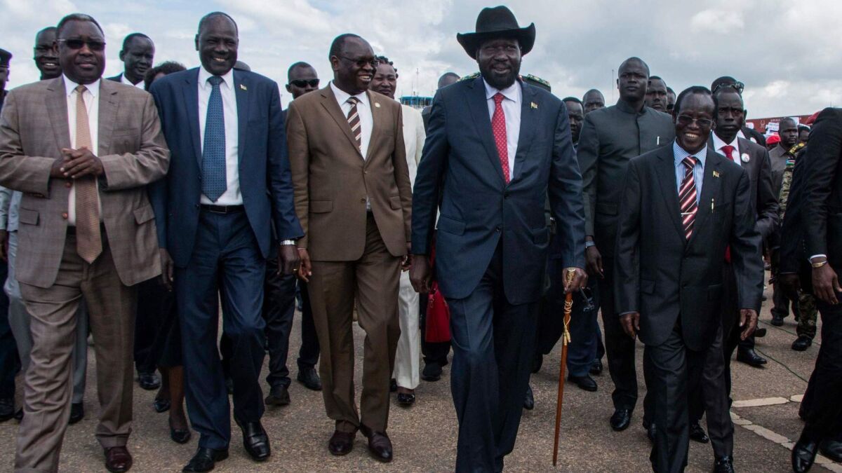South Sudan's President Salva Kiir, second from left, arrives in Juba, the capital, on Friday. Kiir returned from Ethiopia's capital after a face-to-face meeting with opposition leader Riek Machar for the first time in almost two years.