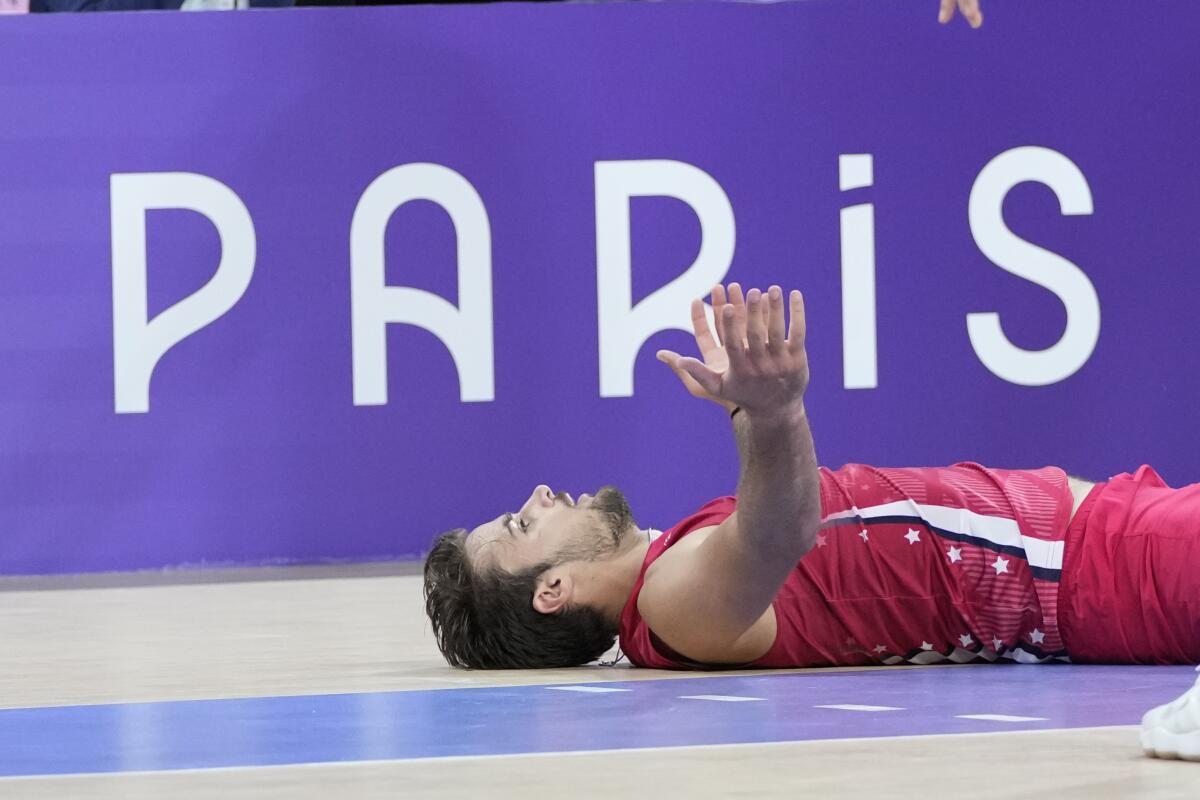 TJ DeFalco celebrates after scoring a point for the United States in its bronze-medal win over Italy.