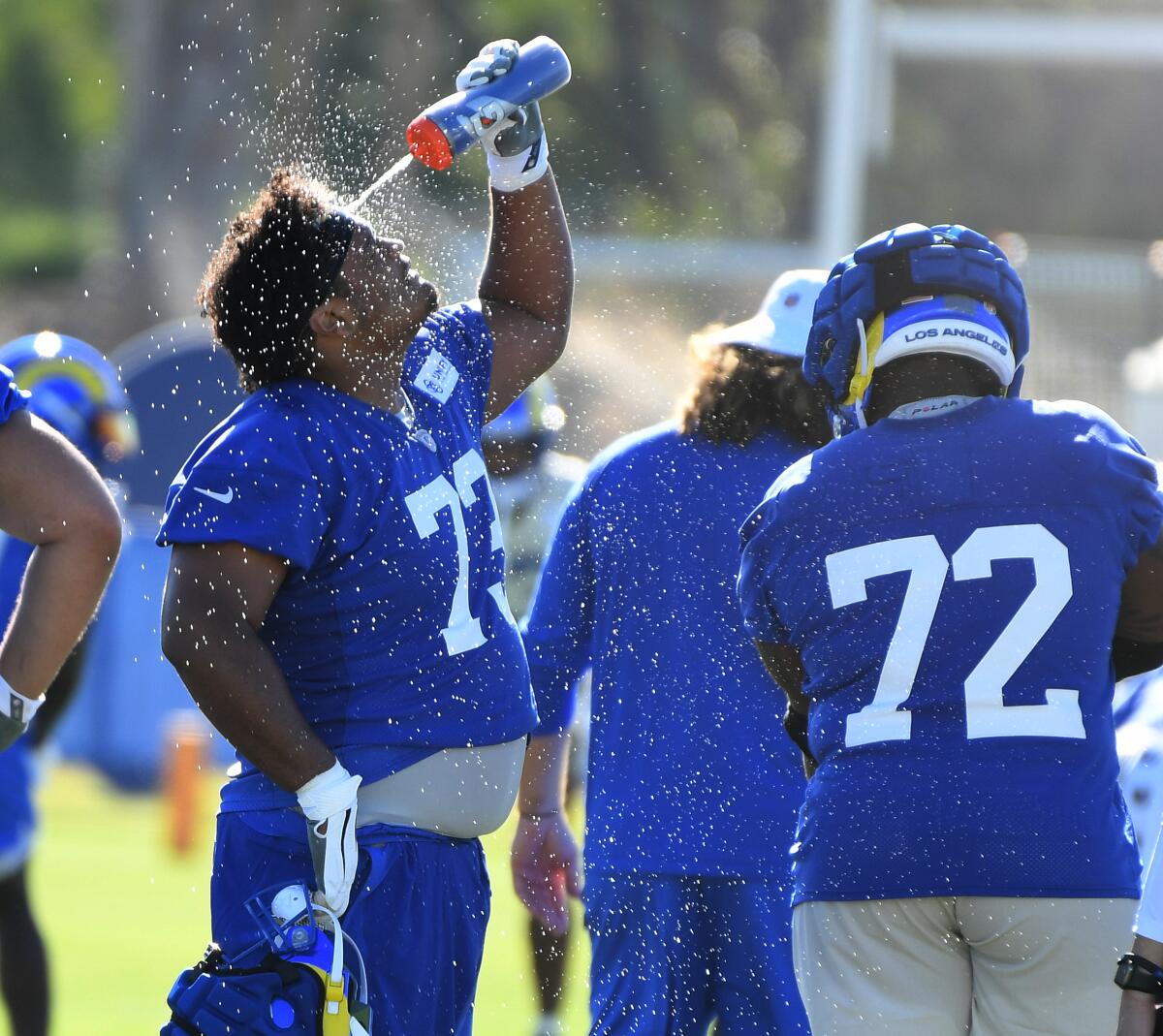 Rams lineman Steve Avila (73)  tries to cool off from the heat during practice.