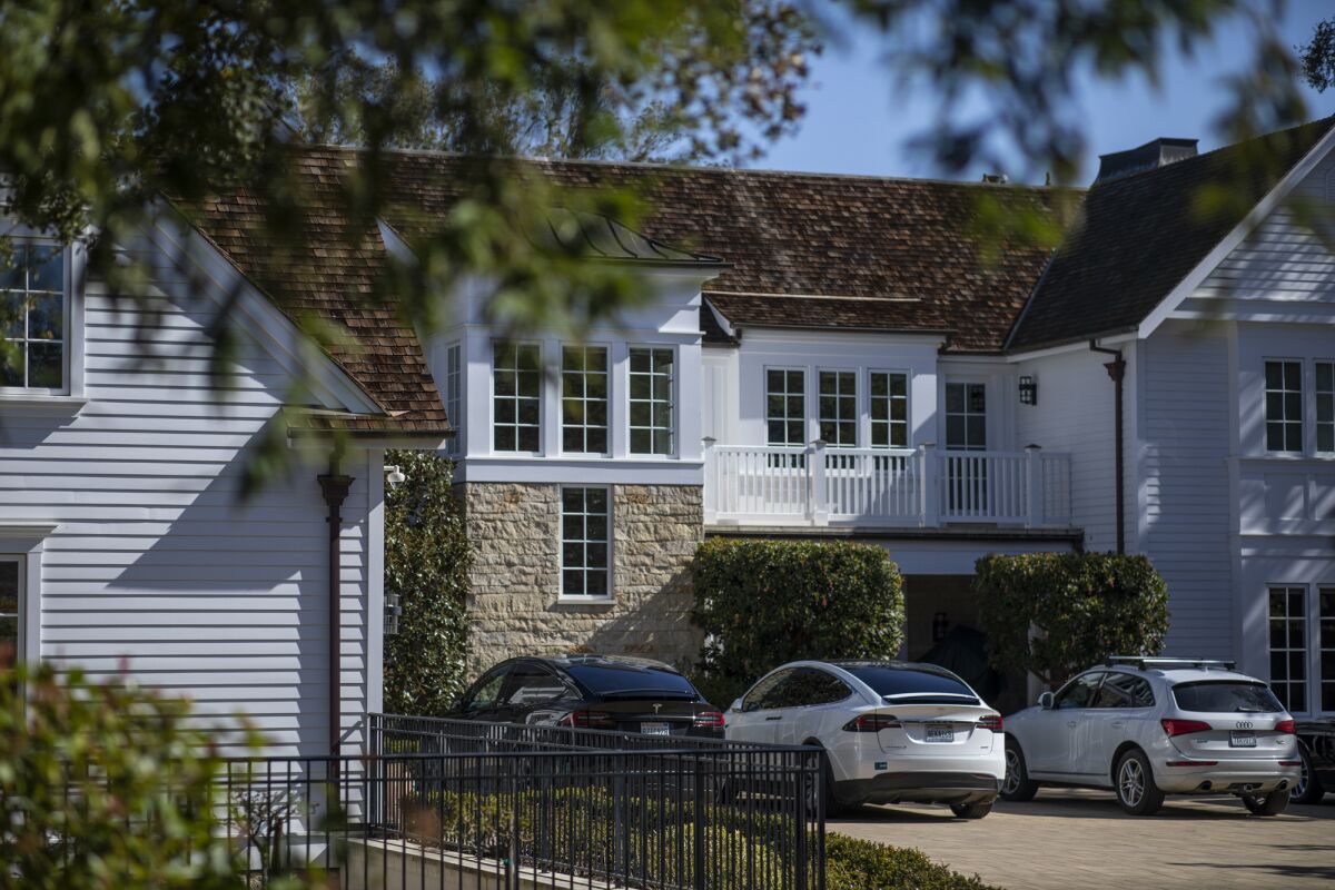 Electric vehicles parked at a home in Atherton on March 16, 2023. Photo by Martin do Nascimento, CalMatters