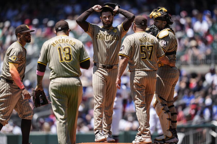 San Diego Padres pitcher Dylan Cease (84) speaks with teammates on the mound in the first inning of a baseball game against the Atlanta Braves, Monday, May 20, 2024, in Atlanta. (AP Photo/Mike Stewart)