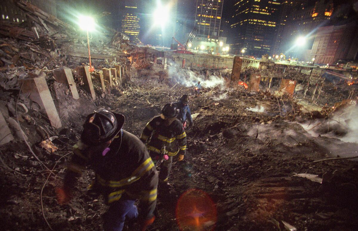 Fall 2001: Members of New York Fire Department Rescue Company 5 search the World Trade Center site looking for victims of the Sept. 11 terror attacks. 