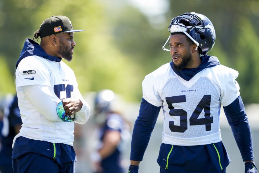 Seattle Seahawks linebacker Jordyn Brooks, left, talks with linebacker Bobby Wagner (54) during NFL football practice, Tuesday, June 6, 2023, at the team's facilities in Renton, Wash. (AP Photo/Lindsey Wasson)