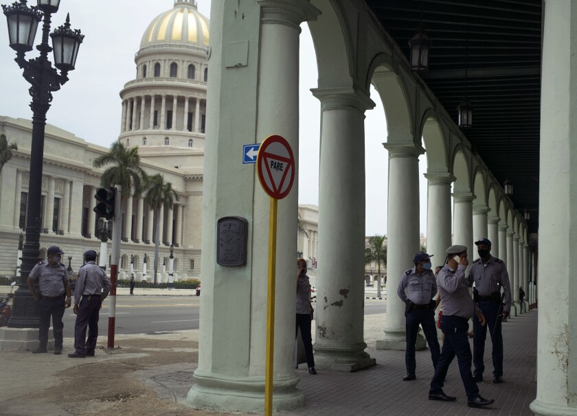 Police stand guard near the National Capitol building in Havana, Cuba, Wednesday, July 14, 2021, days after protests. Demonstrators voiced grievances on Sunday against goods shortages, rising prices and power cuts, and some called for a change of government. (AP Photo/Eliana Aponte)