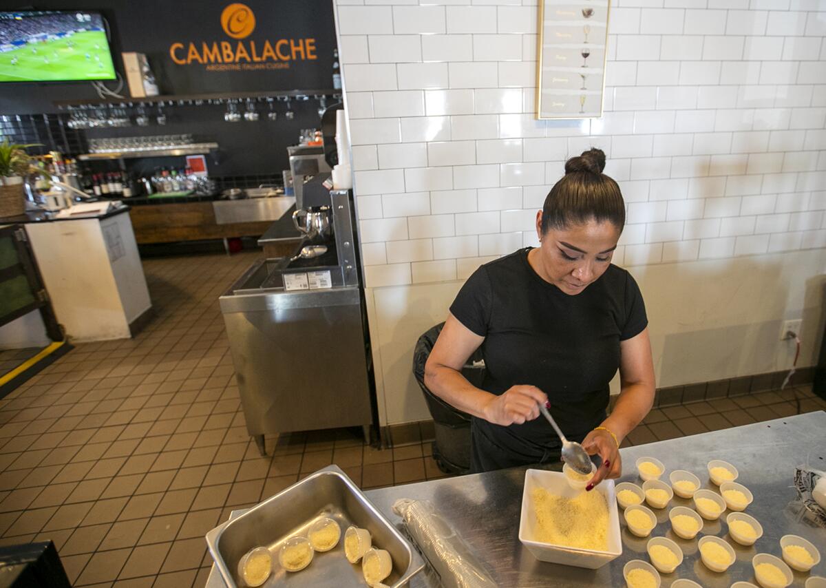 Anna Barron, with Cambalache Grill Argentine and Italian Cuisine, does prep work in April 2023.