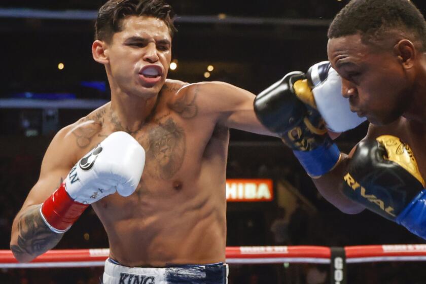 FILE - Ryan Garcia, left, hits Javier Fortuna, right, during a lightweight boxing bout July 16, 2022, in Los Angeles. The fighters seemed just as surprised as fight fans when it was announced that Garcia and Devin Haney, two Californians, would have their April 20, 2024, title fight in New York. But Oscar De La Hoya, Garcia’s promoter, says bringing the event to Brooklyn is common sense. (AP Photo/Ringo H.W. Chiu, File)