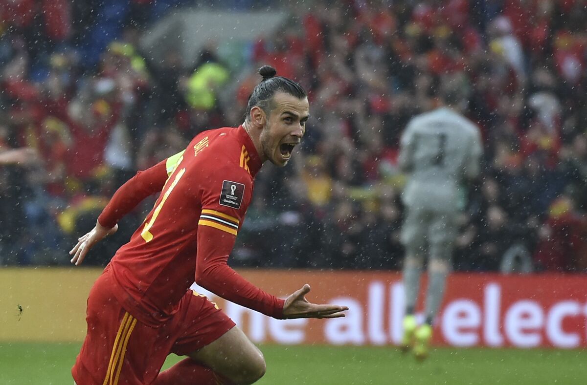 Wales Gareth Bale celebrates after scoring his side's opening goal during the World Cup 2022 qualifying play-off soccer match between Wales and Ukraine at Cardiff City Stadium, in Cardiff, Wales, Sunday, June 5, 2022. (AP Photo/Rui Vieira)