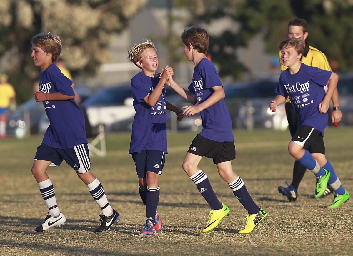 Mariners' Jake Levine, second from left, celebrates with his team after scoring a goal against Rea during the Daily Pilot Cup tournament on Thursday.