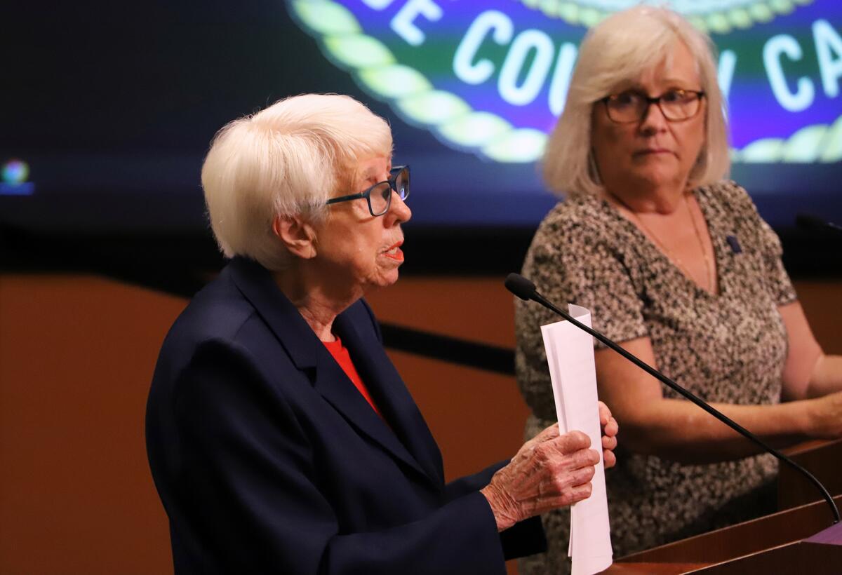 Shirley Dettoff, left, speaks to the Huntington Beach City Council on Tuesday night as Elaine Bauer-Keeley, right, listens.