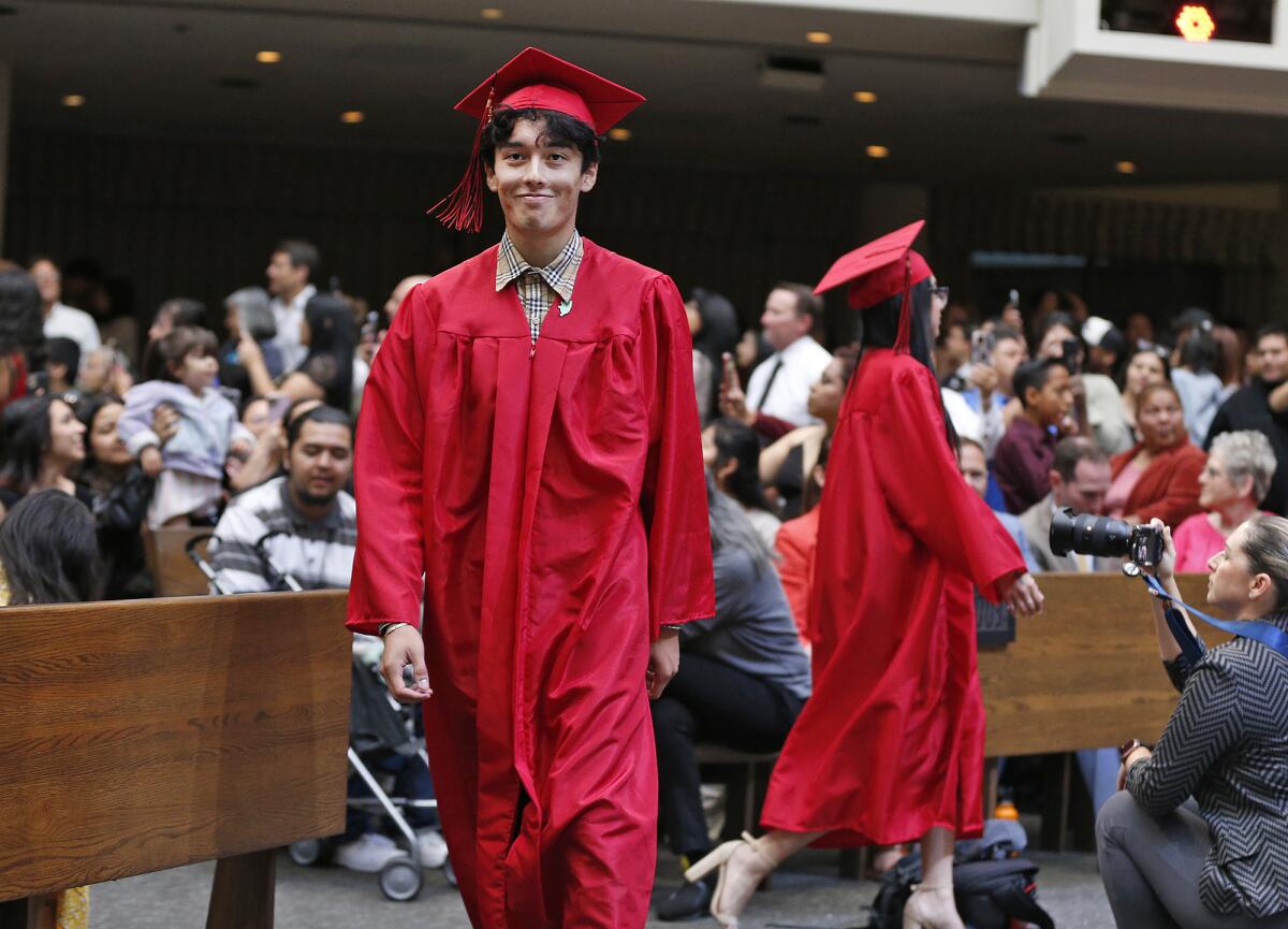 A proud graduate walks into the Back Bay/Monte Vista High School graduation ceremony.