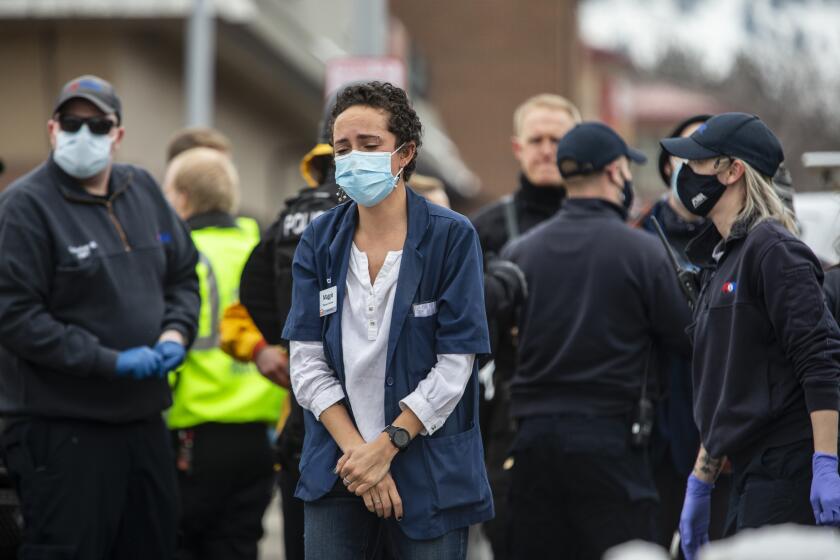 BOULDER, CO - MARCH 22: Healthcare workers walk out of a King Sooper's Grocery store after a gunman opened fire on March 22, 2021 in Boulder, Colorado. Dozens of police responded to the afternoon shooting in which at least one witness described three people who appeared to be wounded, according to published reports. (Photo by Chet Strange/Getty Images))