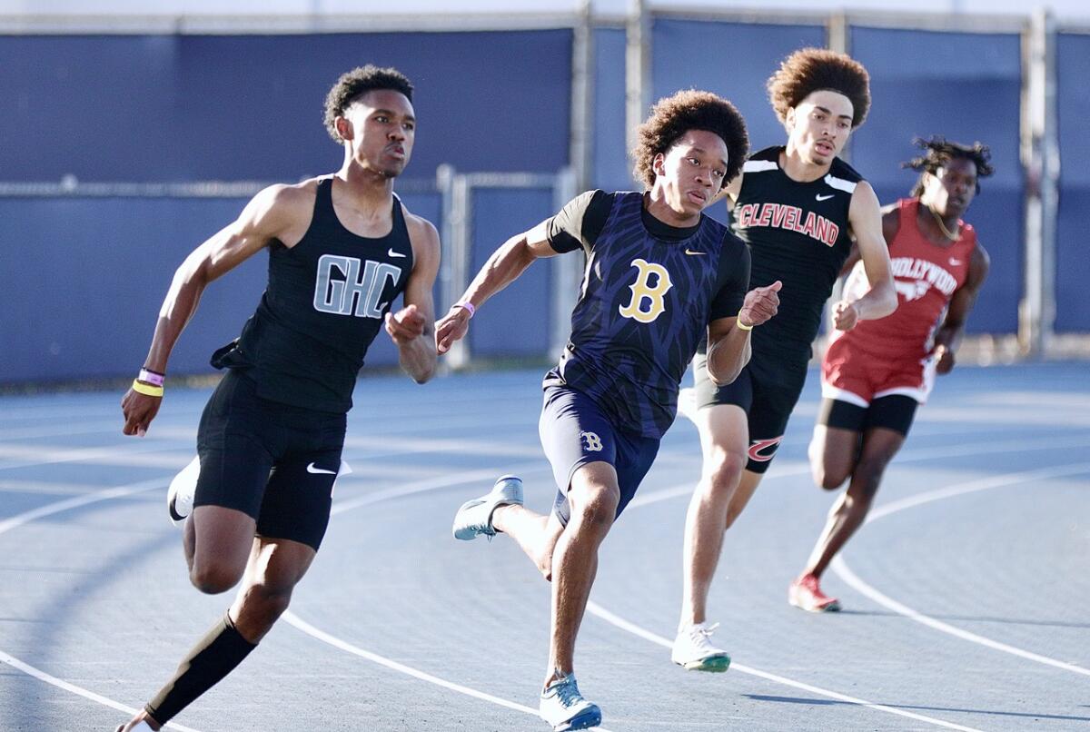Birmingham’s Antrell Harris, center, runs stride for stride with Granada Hills’ Justin Hart in the boys' 200-meter final.