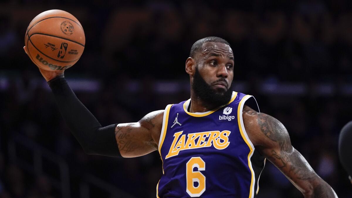 Los Angeles Lakers' LeBron James passes the ball during the second half of an NBA basketball game.