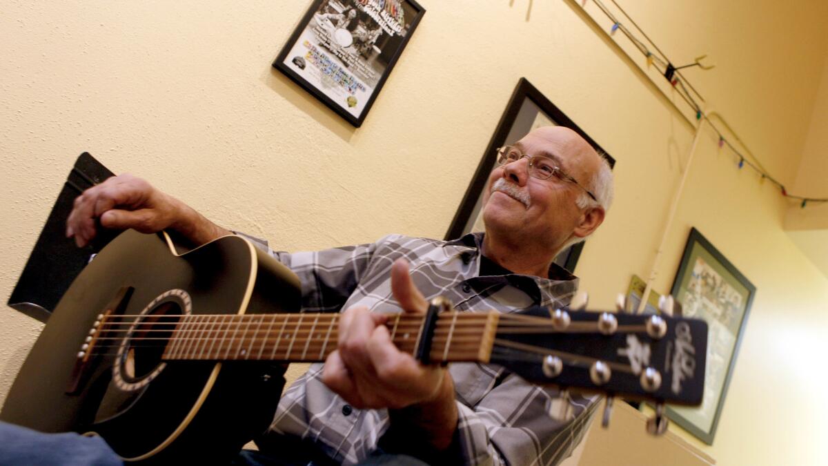 Robert Owen, an Army veteran and folk musician, smiles after performing a song for the Soldier Songs and Voices group during a recent gathering at Artichoke Music in Portland.