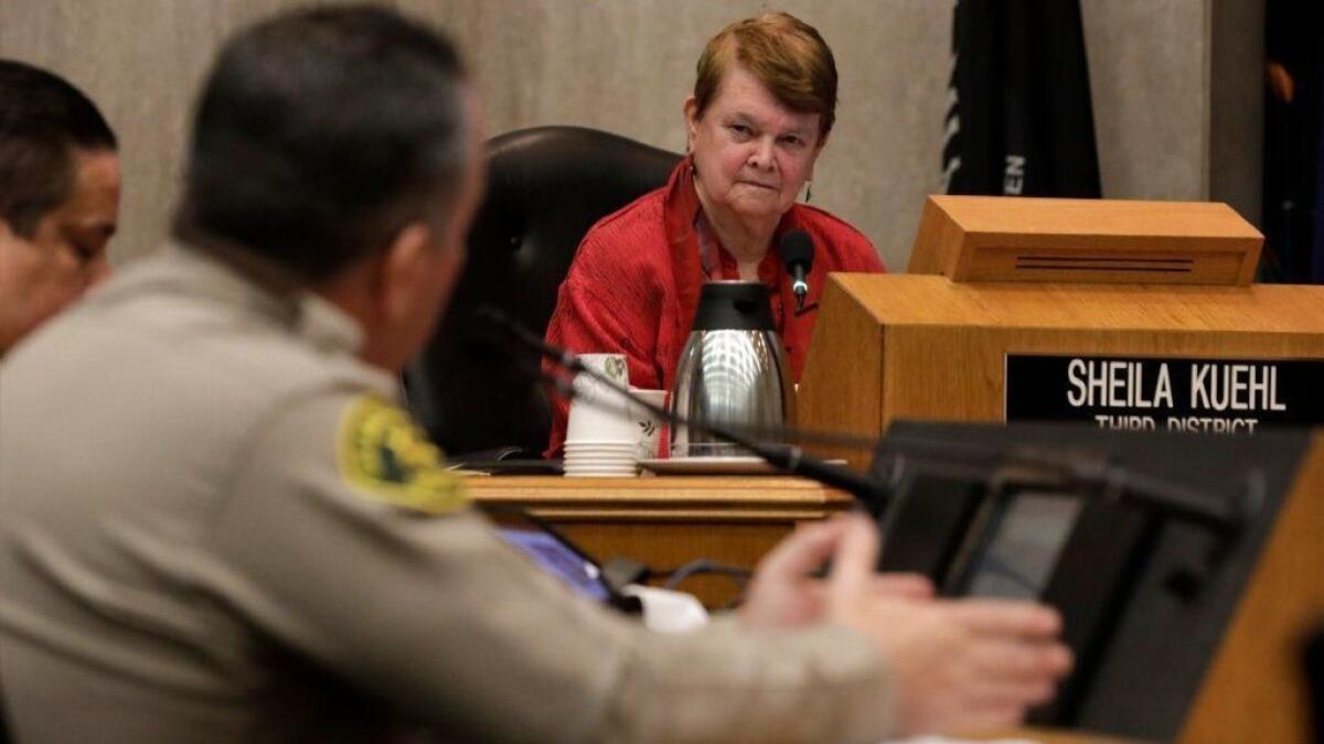 Los Angeles County Supervisor Sheila Kuehl listens to Sheriff Alex Villanueva during a hearing in January over his controversial reinstatement of a deputy, Caren Carl Mandoyan, who was fired over allegations of domestic violence.