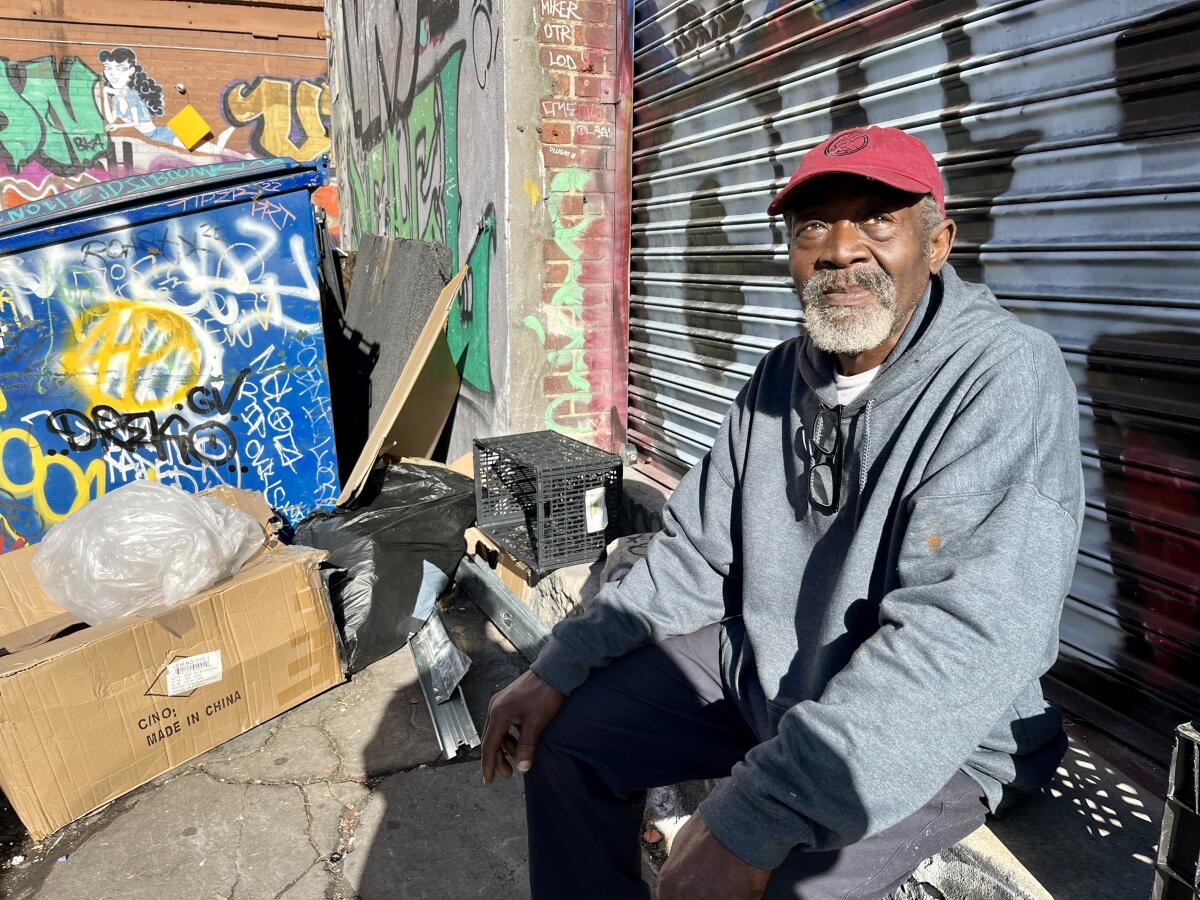 Earlie King Jr., 65, sits in a downtown Los Angeles alley where graffiti covers almost everything