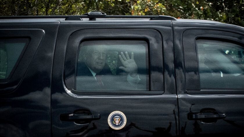 President Trump waves to supporters as the presidential motorcade crosses Bingham Island in Palm Beach, Fla., on April 16, 2017.