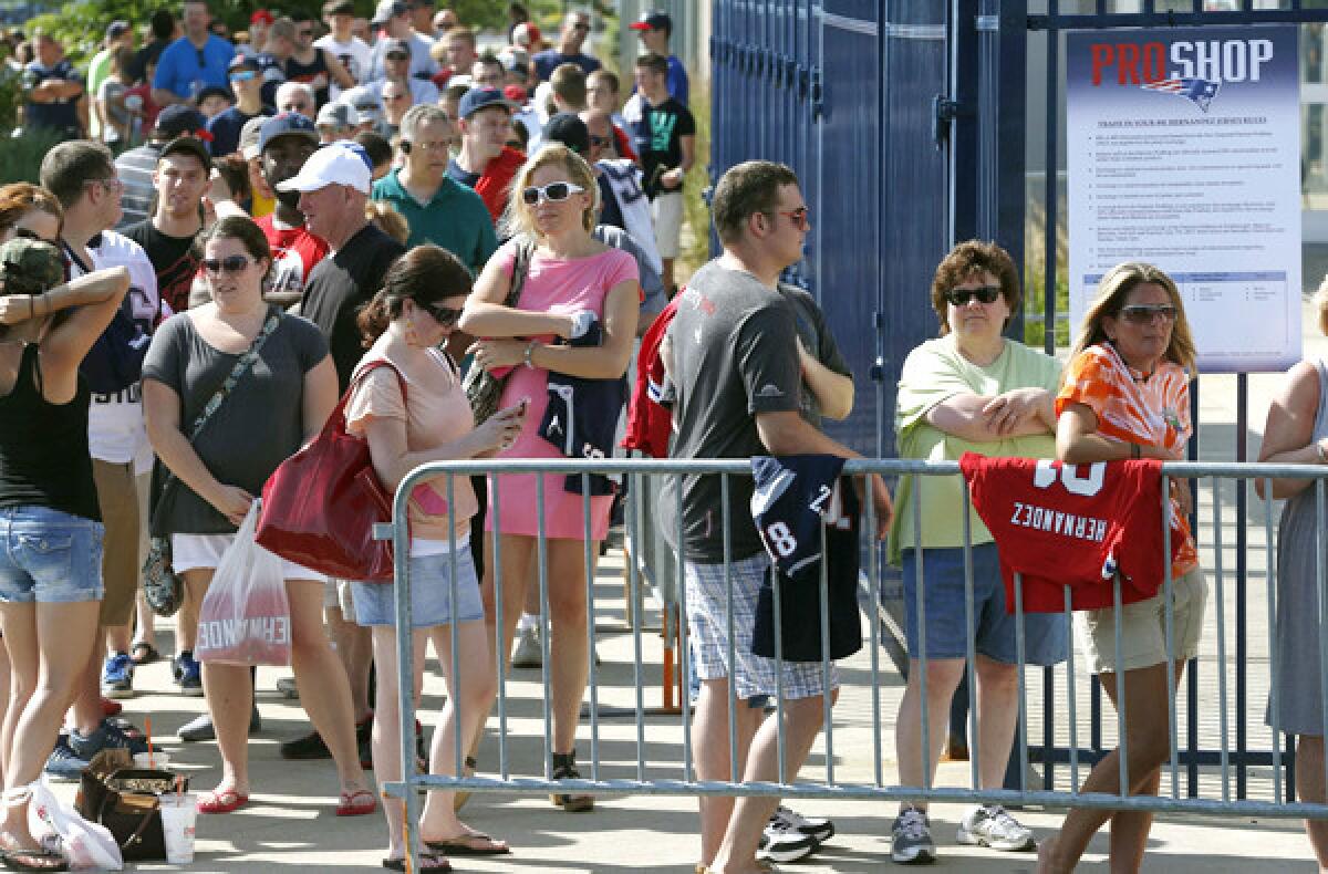 Patriots fans line up to exchange their Aaron Hernandez football jerseys at Gillette Stadium on Saturday.