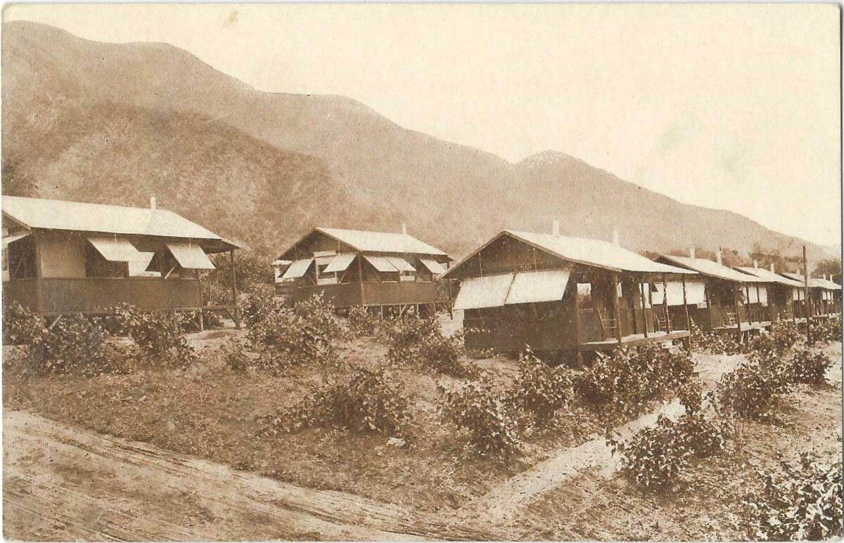 A sepia-tone image shows sanitarium cottages with porches and awnings in a foothill setting