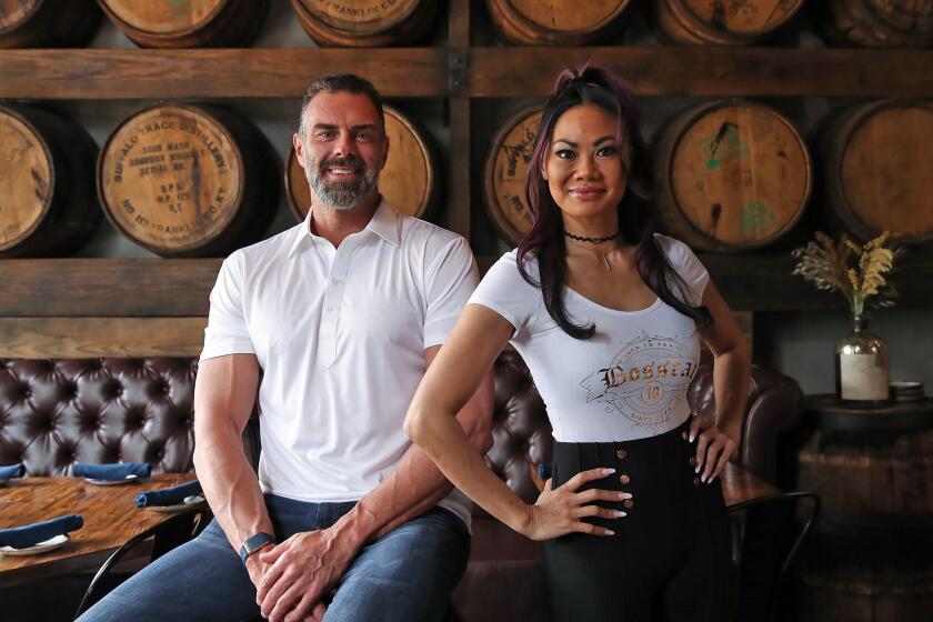 Founders John Reed and Leslie Nguyen in the dining room of the new Bosscat Kitchen & Libations in Irvine. Daily Dose Hospitality has grown to include not only Bosscat Kitchen & Libations, but TEN Sushi + Cocktail and Byblos Cafe as well.