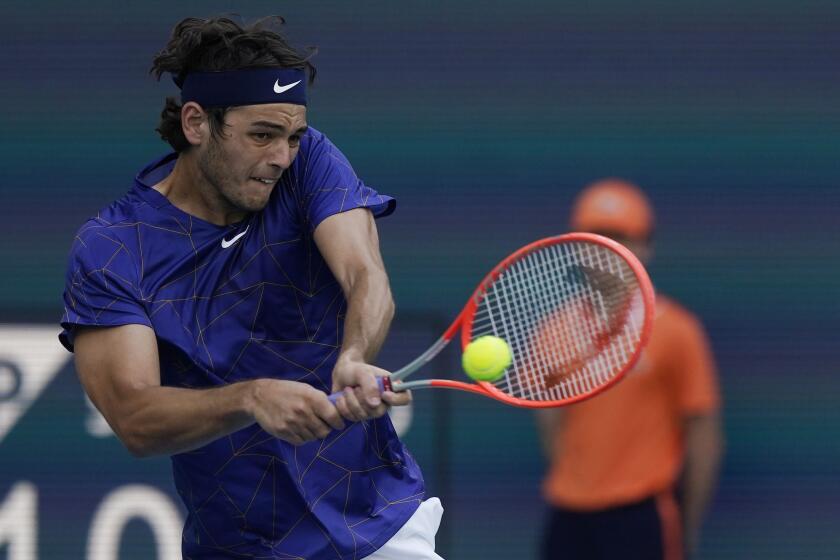 Taylor Fritz of the U.S., returns the ball to Mikhail Kukushkin of Kazakhstan.