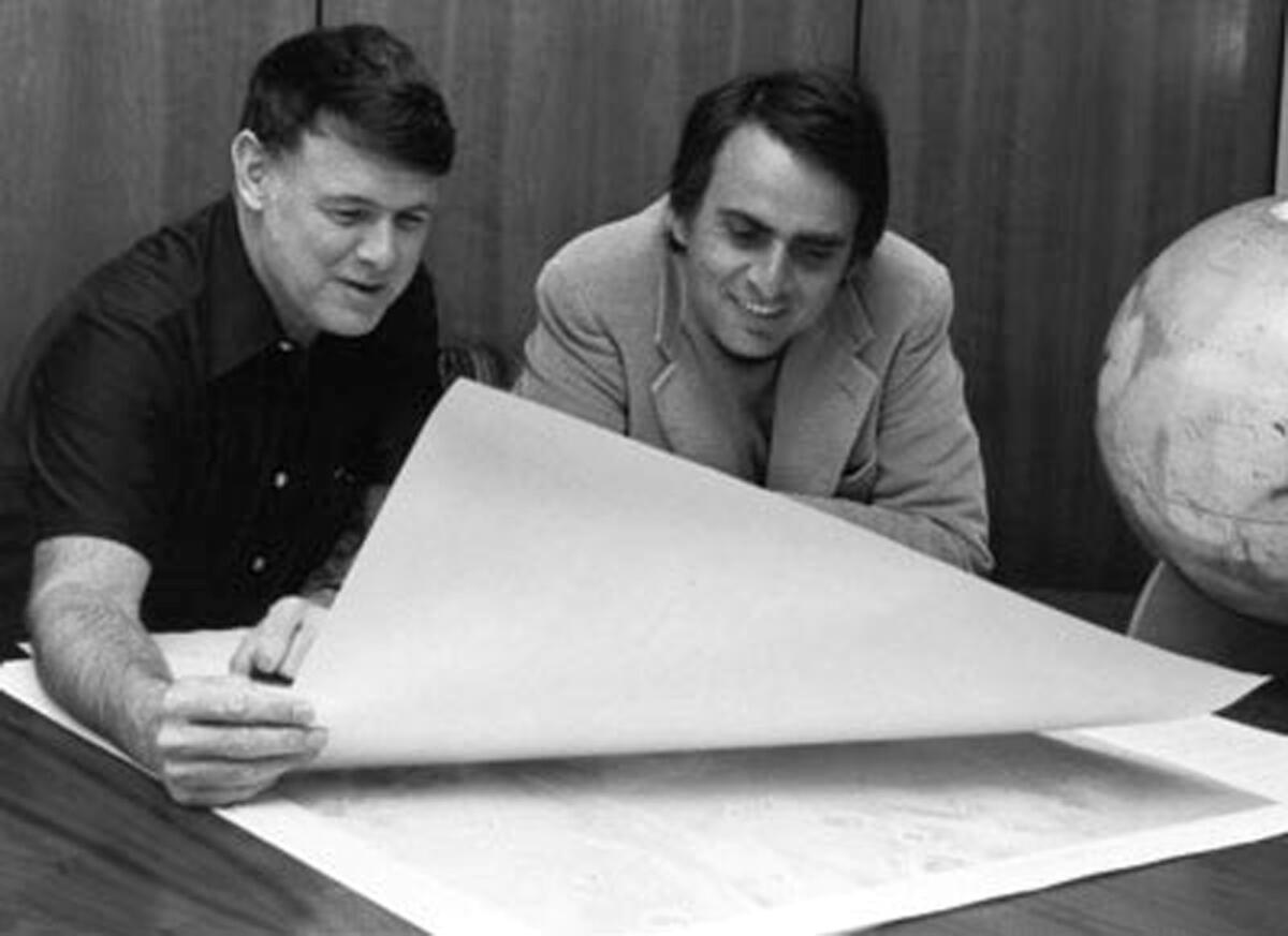 Carl Sagan, right, the creator and presenter of the PBS science series "Cosmos."