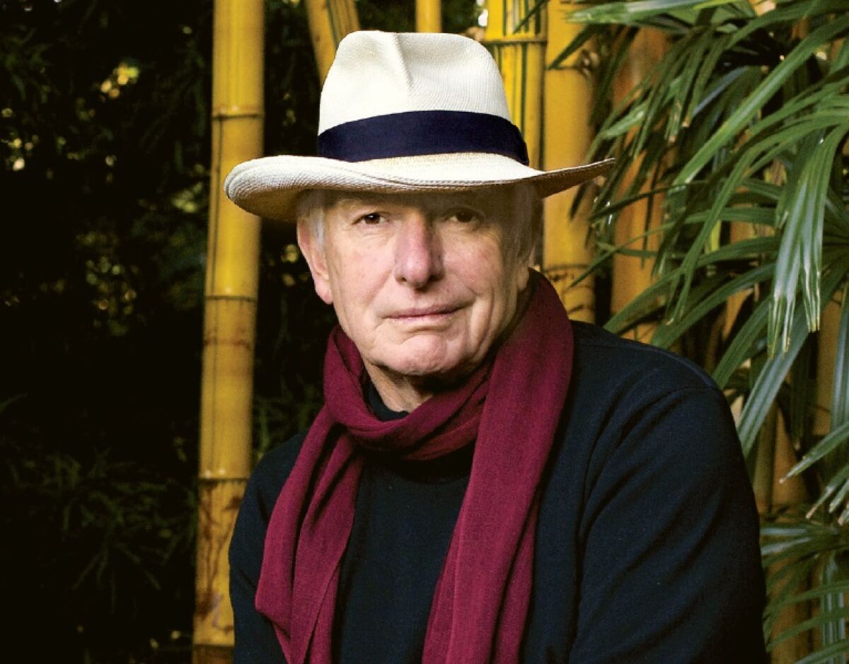 Peter Weir wears a scarf and hat for a portrait.