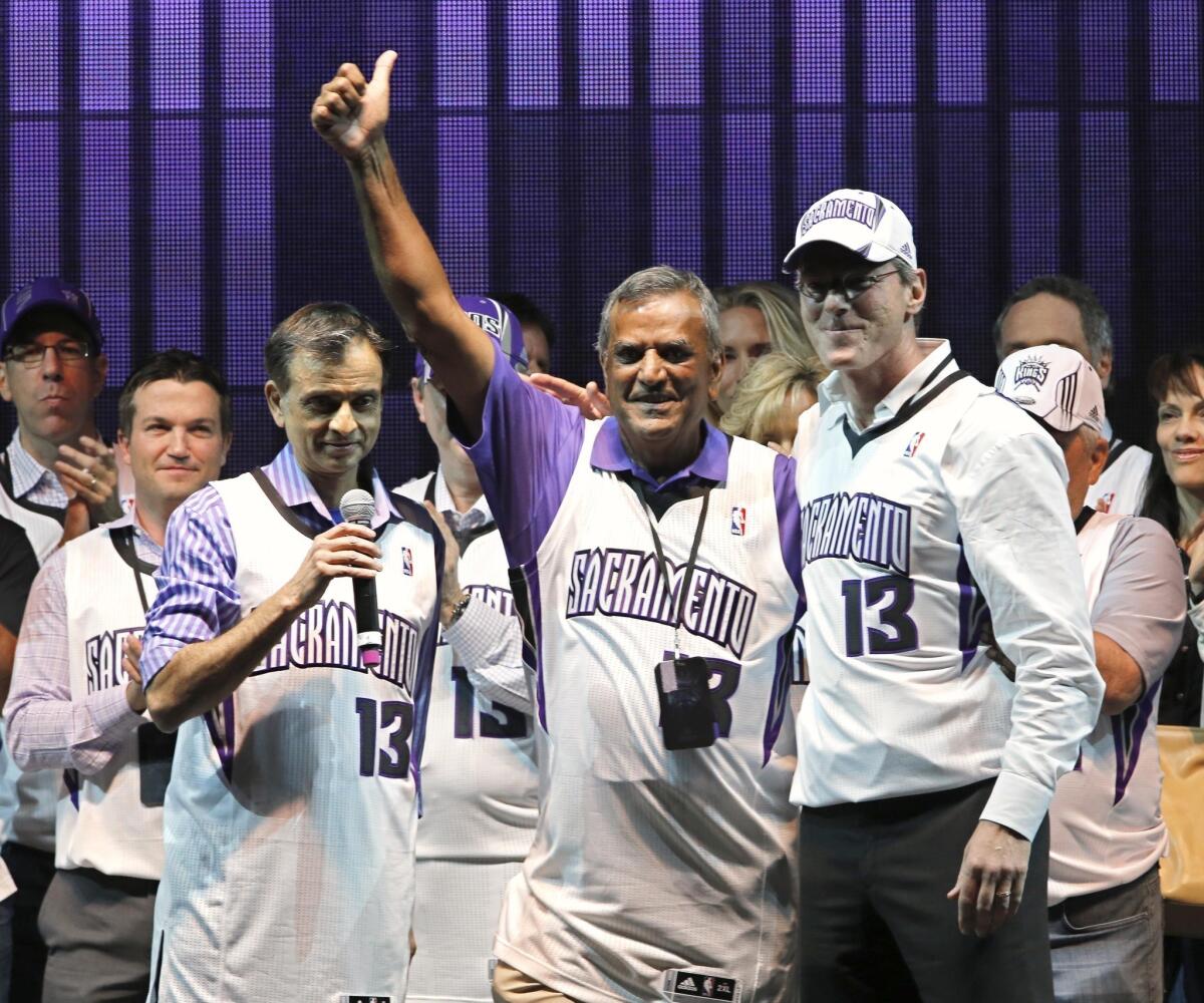 New Kings majority owner Vivek Ranadive, left, introduces Sacramento Kings investors Raj Bhathal, center, and Paul Jacobs at a team rally.