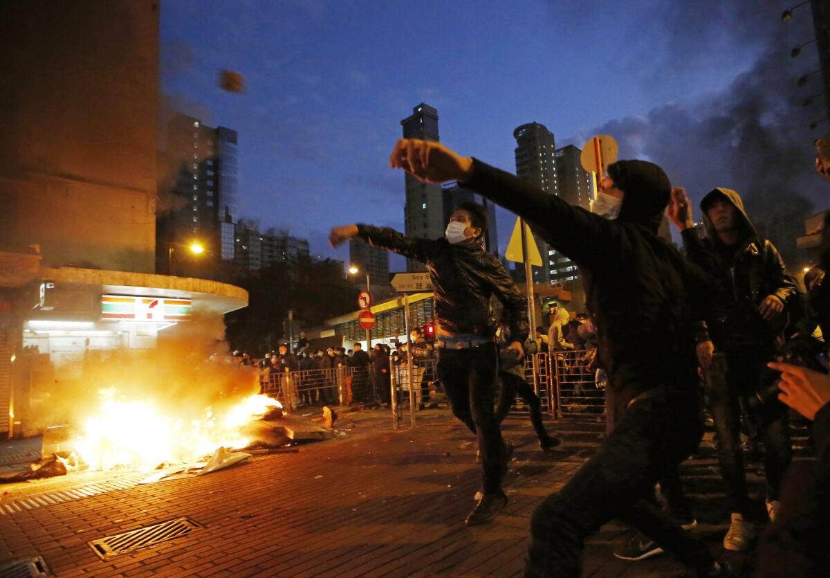 Rioters throw bricks at police in Hong Kong's Mong Kok district on Feb. 9.