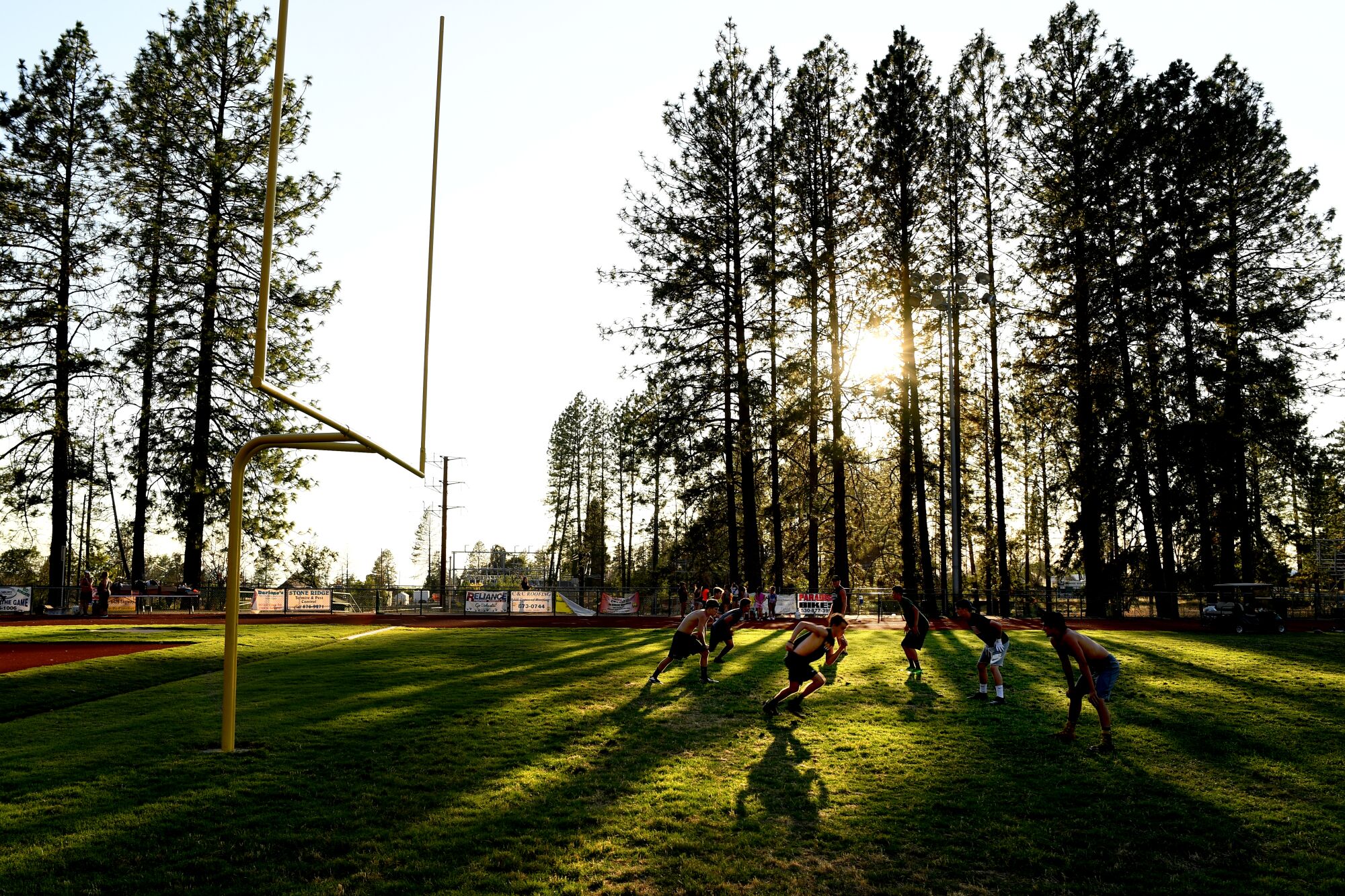 Paradise High football players practice in the late afternoon in preparation for the upcoming season.
