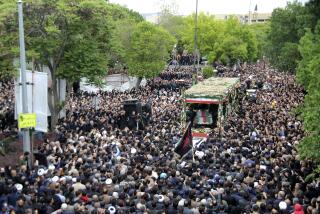 In this photo provided by Fars News Agency, mourners gather around a truck carrying coffins of Iranian President Ebrahim Raisi and his companions who were killed in a helicopter crash on Sunday in a mountainous region of the country's northwest, during a funeral ceremony at the city of Tabriz, Iran, Tuesday, May 21, 2024. Mourners in black began gathering Tuesday for days of funerals and processions for Iran's late president, foreign minister and others killed in a helicopter crash, a government-led series of ceremonies aimed at both honoring the dead and projecting strength in an unsettled Middle East. (Ata Dadashi, Fars News Agency via AP)