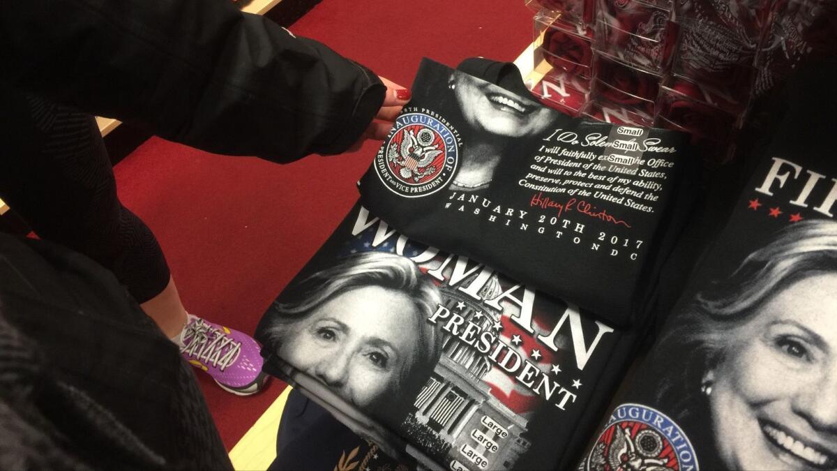 People examine Hillary Clinton T-shirts at a gift shop near the White House.