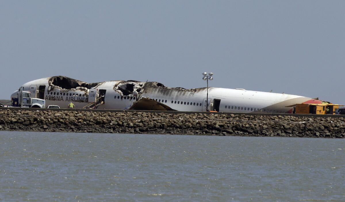 The wreckage of Asiana Airlines Flight 214, which crashed on Saturday, rests on a tarmac at San Francisco International Airport.