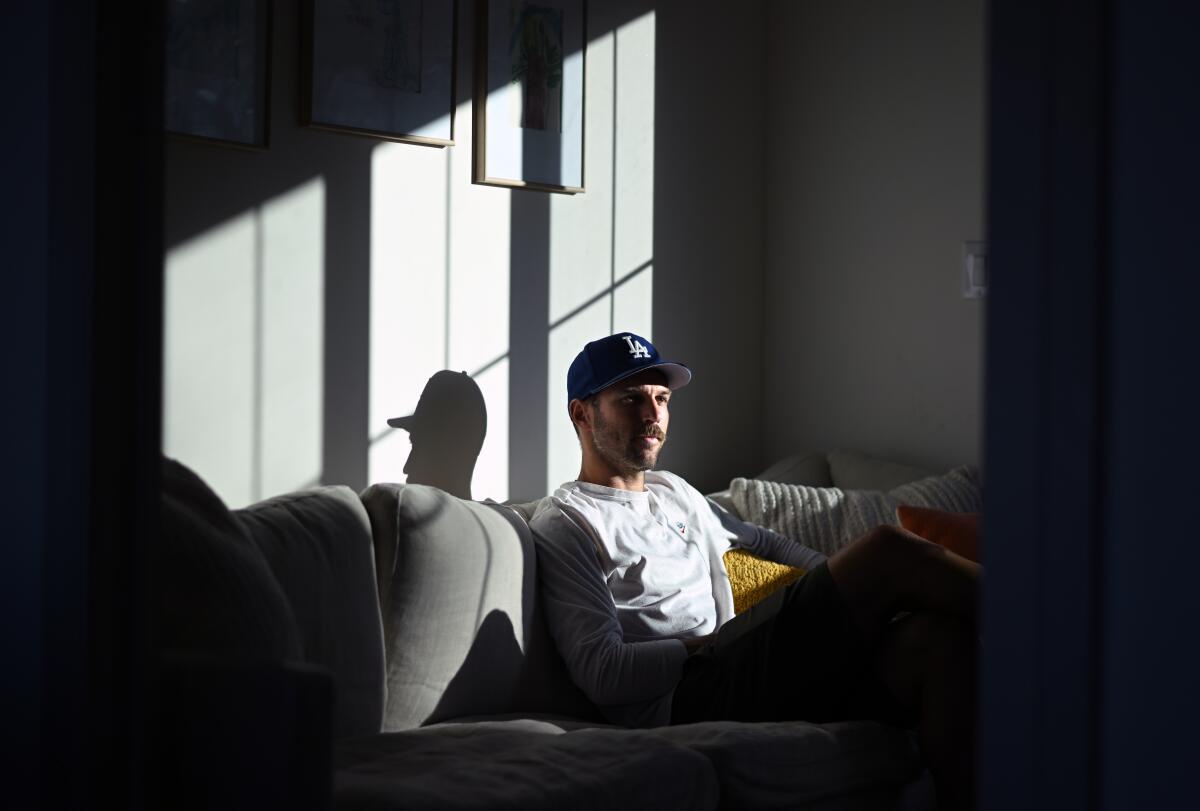 LAFC defender Ryan Hollingshead sits on a couch on his home as the sunlight hits his face