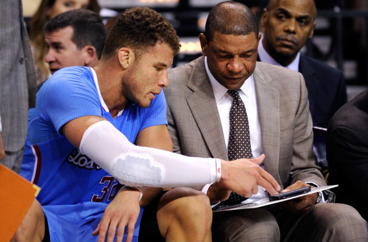 One can only presume that forward Blake Griffin is discussing strategy and not who should get playing time with Coach Doc Rivers.