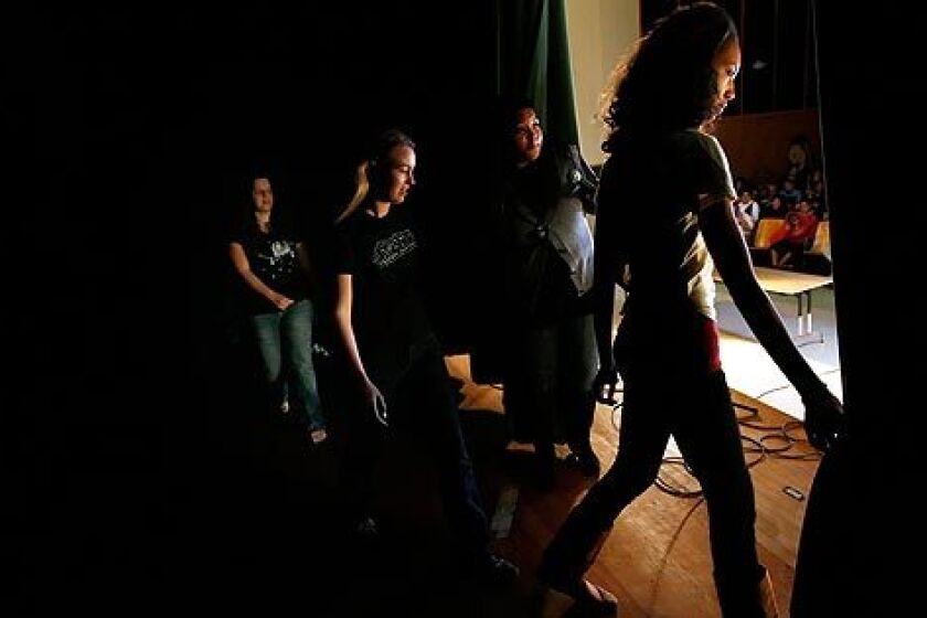 Jazmine Williams, 15, a sophomore at Hamilton High, leads other Get Lit Players onto the stage during a performance at Dorsey High. Audio slide show >>>