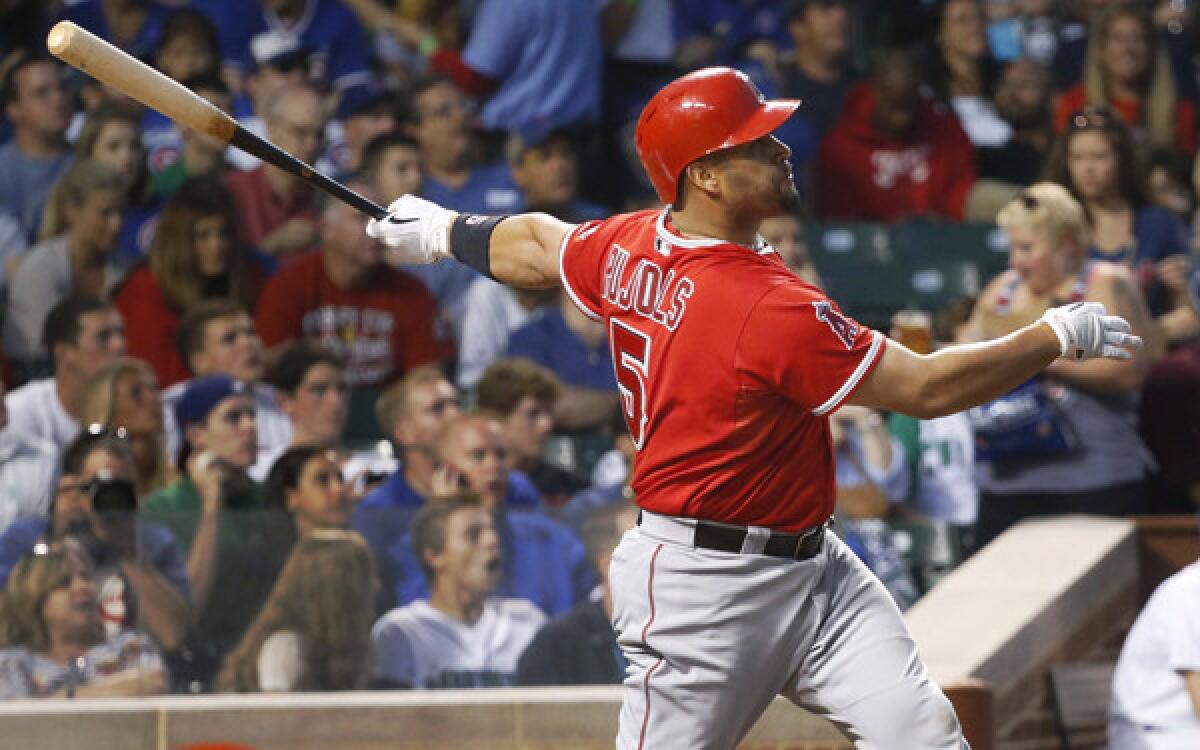 Angels first baseman Albert Pujols watches his two-run home run off Chicago Cubs starting pitcher Jeff Samardzija in the fifth inning of an interleague game Wednesday at Wrigley Field.