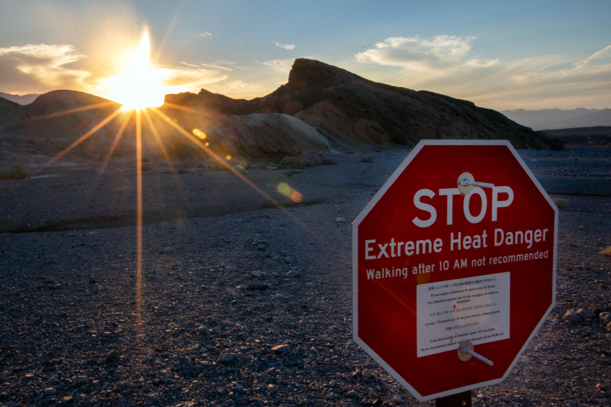 A sign warns of extreme heat danger at Zabriskie Point in Death Valley.