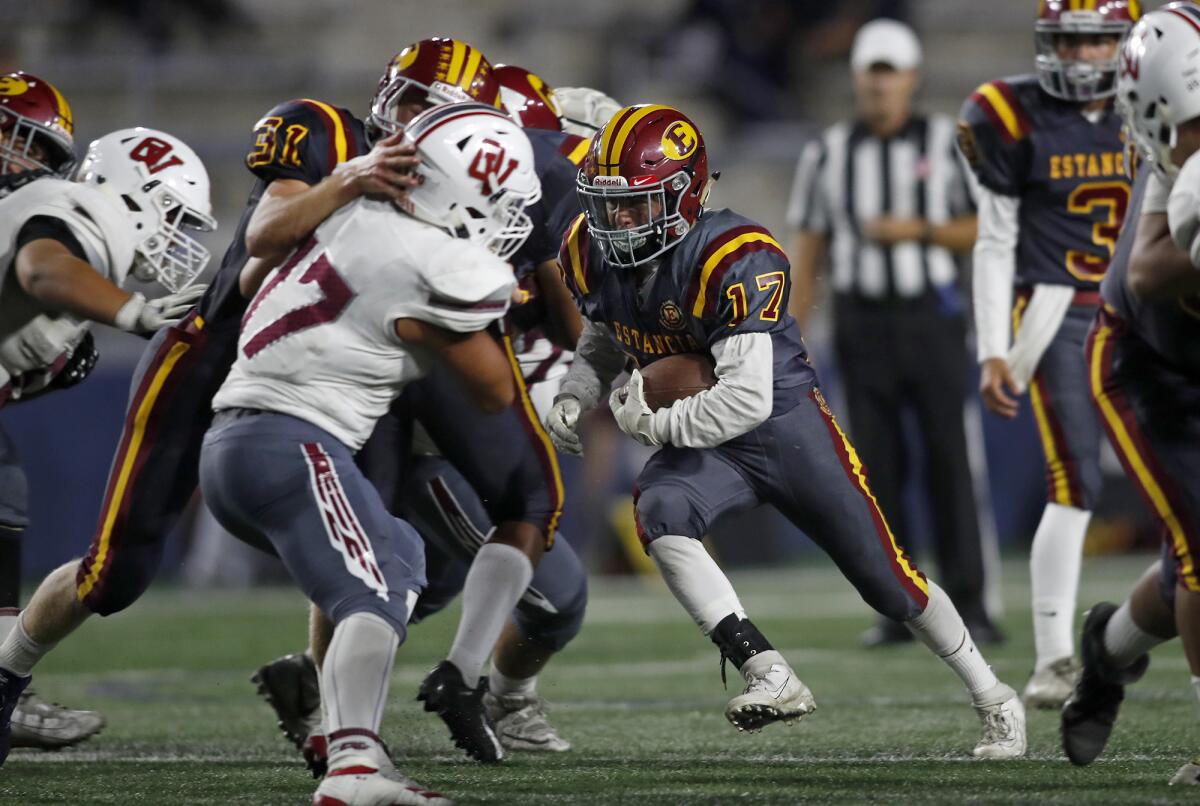 Estancia running back Beto Sotomayor (17) carries the ball against Ocean View in the nonleague game at Orange Coast College on Thursday.