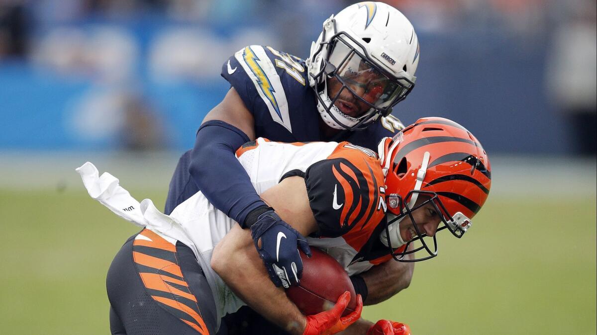 Adrian Phillips tackles Cincinnati wide receiver Alex Erickson on Dec. 9. Phillips has accumulated 63 tackles, one interception and eight pass breakups for the Chargers this season.