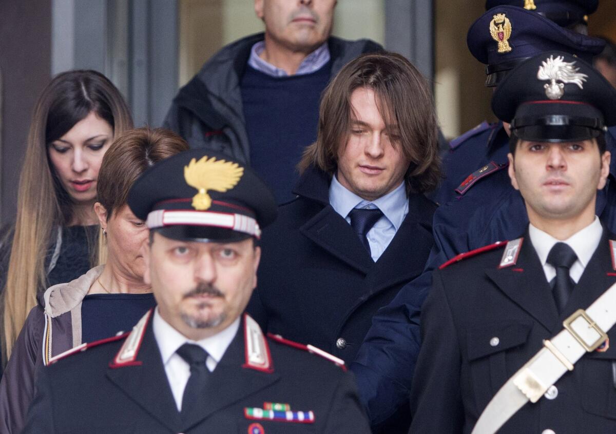 Raffaele Sollecito, center, leaves Italy's highest court building in Rome on March 27.