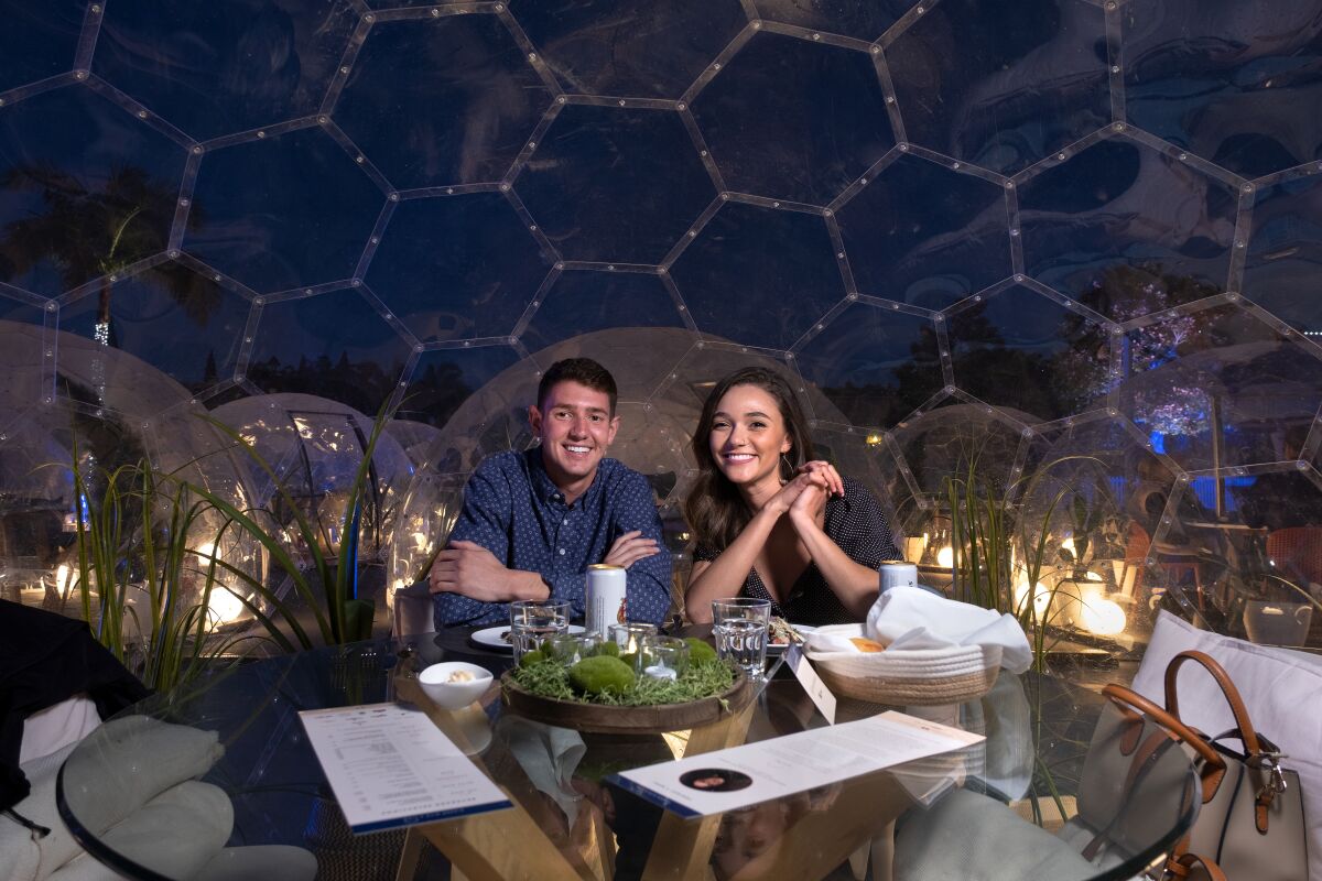 Haley and Kyle eat inside a see-through dome at Dinner With A View in Liberty Station.