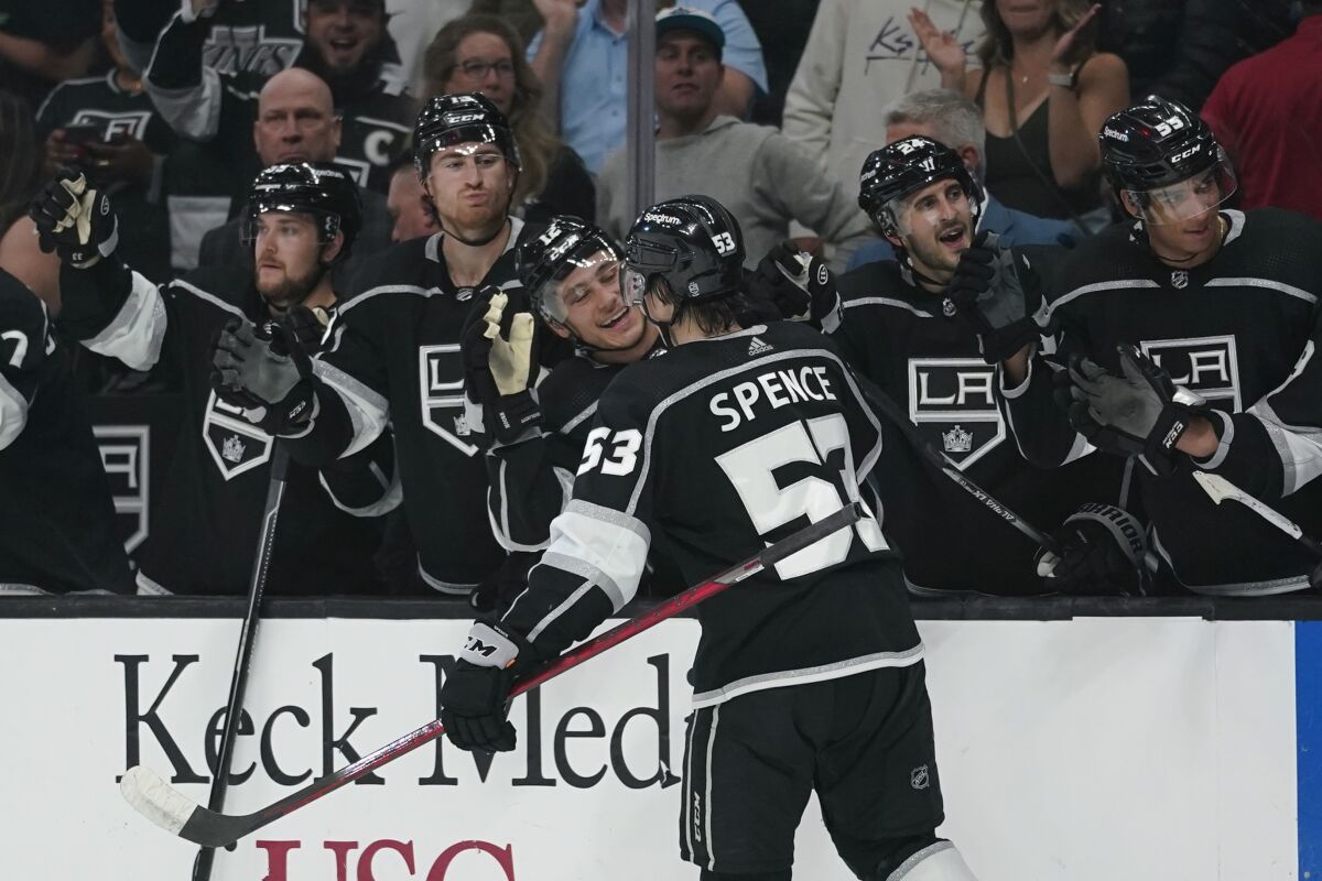 Kings defenseman Jordan Spence celebrates with teammates after scoring his first career goal.
