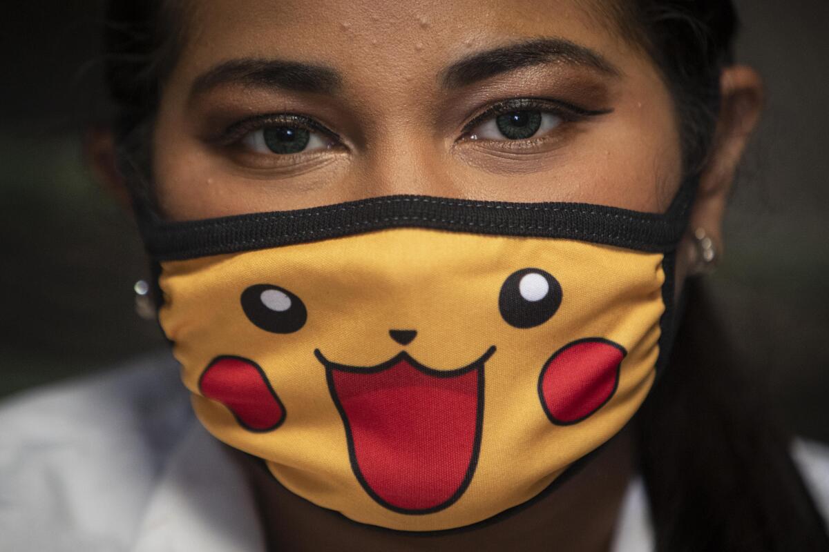 A doctor wears a face mask