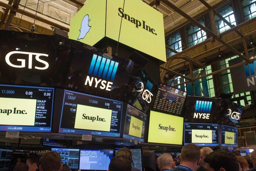 (FILES) This file photo taken on March 2, 2017 shows traders working on the floor during the Snap Inc. IPO at the New York Stock Exchange in New York. Snapchat parent Snap Inc. disclosed on November 8, 2017 that Chinese tech giant Tencent had taken a 12 percent stake, in a sign of confidence in the social network which has delivered disappointing results since its share offering this year.A securities filing showed Tencent Holdings had purchased some 146 million shares of Snap non-voting stock in open market purchases in November. / AFP PHOTO / Bryan R. SmithBRYAN R. SMITH/AFP/Getty Images ** OUTS - ELSENT, FPG, CM - OUTS * NM, PH, VA if sourced by CT, LA or MoD **